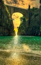 Fiordo di Furore, Amalfi golden hour sunset seascape view from beach on arched bridge between rocks and turquoise sea. Royalty Free Stock Photo