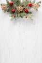 Fir branch with Christmas decoration on white shabby wooden board with copy space for text. Flat lay.  Christmas background Royalty Free Stock Photo