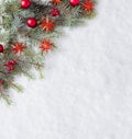 Fir branch with Christmas decorations on the background of natural snow