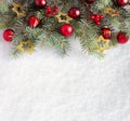 Fir branch with Christmas decorations on the background of natural snow Royalty Free Stock Photo