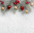 Fir branch with Christmas decorations on the background of natural snow Royalty Free Stock Photo