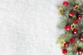 Fir branch with Christmas decorations on the background of natural snow Royalty Free Stock Photo