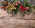 Fir branch with Christmas decorations on old wooden plank Royalty Free Stock Photo