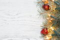 Fir branch with Christmas decorations on old wooden shabby background with copy space for text Royalty Free Stock Photo