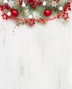 Fir branch with Christmas decorations on old wooden shabby background with empty space for text. Top view Royalty Free Stock Photo