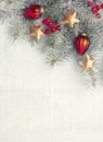 Fir branch with Christmas decorations on white old wooden background with copy space for text. Tone image Royalty Free Stock Photo