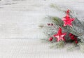 Fir branch with Christmas decorations on white rustic wooden background Royalty Free Stock Photo