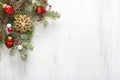 Fir branch with Christmas decorations on white shabby wooden board with copy space for text. Flat lay.  Christmas and New Year hol Royalty Free Stock Photo