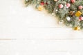 Fir branch with Christmas decorations on the white wooden table or plank background Royalty Free Stock Photo