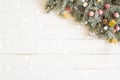 Fir branch with Christmas decorations on the white wooden table or plank background Royalty Free Stock Photo