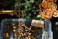 Fir branches, acorns, cones, dried pieces of fruit for the New Year wreath lie on a tray on the table