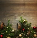 Fir branches on blured wooden background with New Year decorations, pine cones and bokeh light. Desing for Christmas Royalty Free Stock Photo