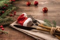 Fir branches and cutlery with Santa hat. table setting with Christmas decorations. Christmas table place setting. Christmas