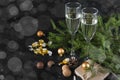 Fir branches, glasses of sparkling wine, chocolates with Golden wrappers, gift box, balloons, champagne, Christmas decor