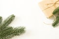 Fir branches with pine cones and gifts in craft paper and scourge on a white background for text for the holiday christmas or new Royalty Free Stock Photo