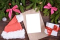 Fir branches, pink ribbon bow, Christmas cap, envelope and christmas balls. New Year background Royalty Free Stock Photo