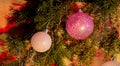 Fir branches with toys, glass balls, tinsel on a light wooden background.Christmas card