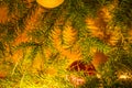 Fir branches with toys, glass balls, tinsel on a light wooden background.Christmas card