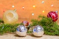 Fir branches with toys, glass balls, tinsel on a light wooden background.Christmas card