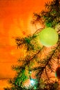 Fir branches with toys, glass balls, tinsel on a light wooden background.Christmas card