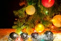 Fir branches with toys, glass balls, tinsel on a light wooden background.Christmas card