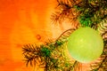 Fir branches with toys, glass balls, tinsel on a light wooden background.Christmas card