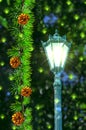 Fir branches with yellow cones and an old beautiful street lamp on an abstract background with bokeh and green stars Royalty Free Stock Photo