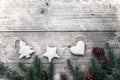 Fir leaves and pine cones decorating rustic elements on vintage wood table with snowflake. Royalty Free Stock Photo