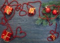 Fir paw, balls, gift, beads, heart on an old, shabby, dark wooden background Royalty Free Stock Photo