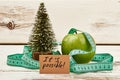 Fir-tree and apple on wood. Royalty Free Stock Photo