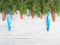 Fir tree branch with cinnamon, cones, snowflakes and blue toys on wooden background Royalty Free Stock Photo