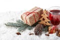 Fir tree branch, decorations, gingerbread cookies and gift boxes on a winter snow background with copy space Royalty Free Stock Photo