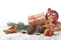 Fir tree branch, decorations, gingerbread cookies and gift boxes on a winter snow background with copy space Royalty Free Stock Photo