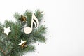 Fir tree branch with decorative golden stars and wooden music note on white background, top view. Christmas celebration Royalty Free Stock Photo