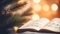 Fir tree branch and festive decor on music sheets, bokeh effect