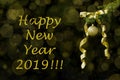 Fir tree branch with golden glitter ball and ribbon on dark background. Bokeh effects. New year greetings postcard Royalty Free Stock Photo