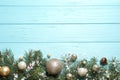 Fir tree branches with Christmas decoration on light blue wooden background, flat lay. Royalty Free Stock Photo