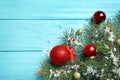 Fir tree branches with Christmas decoration on light blue wooden background. Space for text Royalty Free Stock Photo