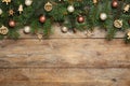 Fir tree branches with Christmas decoration on wooden background. Space for text Royalty Free Stock Photo