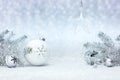 Fir tree branches and christmas decorations against white snow background Royalty Free Stock Photo