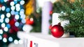 Fir tree branches with red new year balls on a background of colorful beautiful bokeh, close-up. Concept of Christmas composition Royalty Free Stock Photo