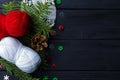 Fir tree branches and yarn balls on wooden table. Christmas knitting concept Royalty Free Stock Photo