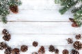 Fir tree and pine cones decorating rustic elements on white wood table with snowflake Royalty Free Stock Photo