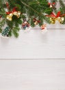 Fir tree twigs and new year ornaments border at white wooden background Royalty Free Stock Photo