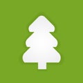 The fir-tree which is cut out from white paper on a green background