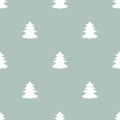 Fir-trees on powder blue background. Forest blizzard. seamless winter pattern with spruce Royalty Free Stock Photo