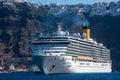 Cruise Ship Costa Deliziosa of Costa cruises facing forward with Fira in background