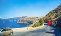 Vehicles moving on narrow winding road to Thira port Greece