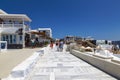 Fira on a sunny summer day with walking tourists. Santorini,