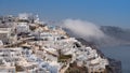 Fira town in Santorini island on summer time with clouds and blue sky
